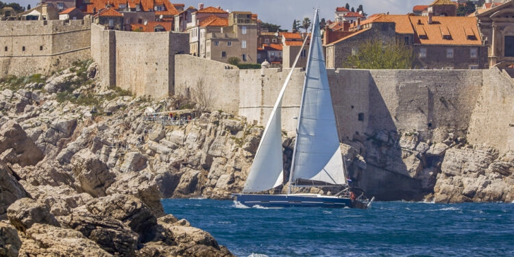 Cruise South Dalmatia by yacht: sailing yacht in front of Dubrovnik city walls