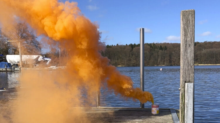 Sea safety training: orange smoke pot