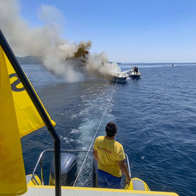 Fire on board: yacht is towed out to sea.