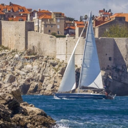 Cruise South Dalmatia by yacht: sailing yacht in front of Dubrovnik city walls